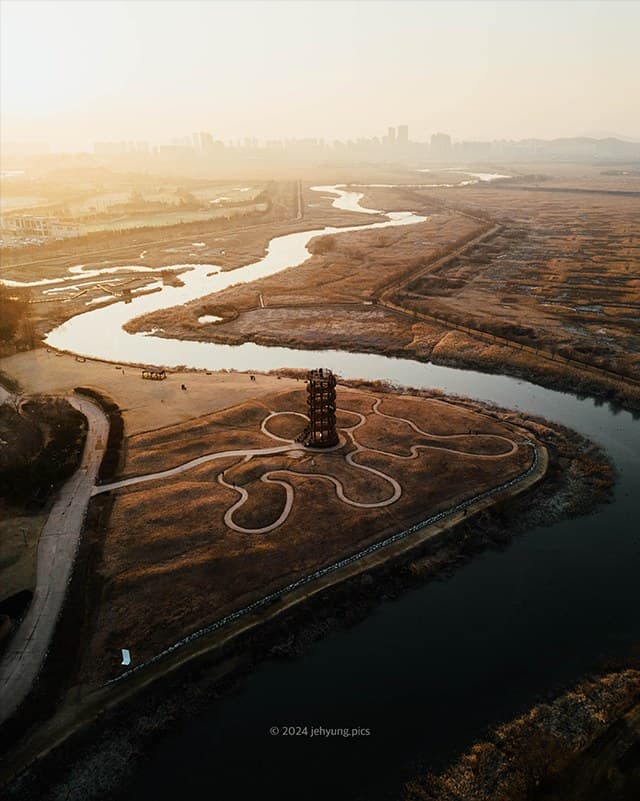 Aerial view of Siheung Gaetgol at golden hour with a winding tidal channel